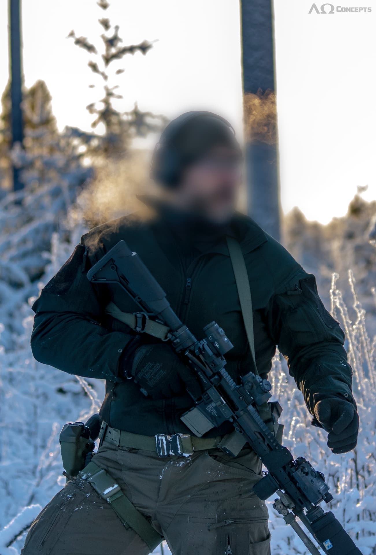 Operator in winter kit with slung rifle