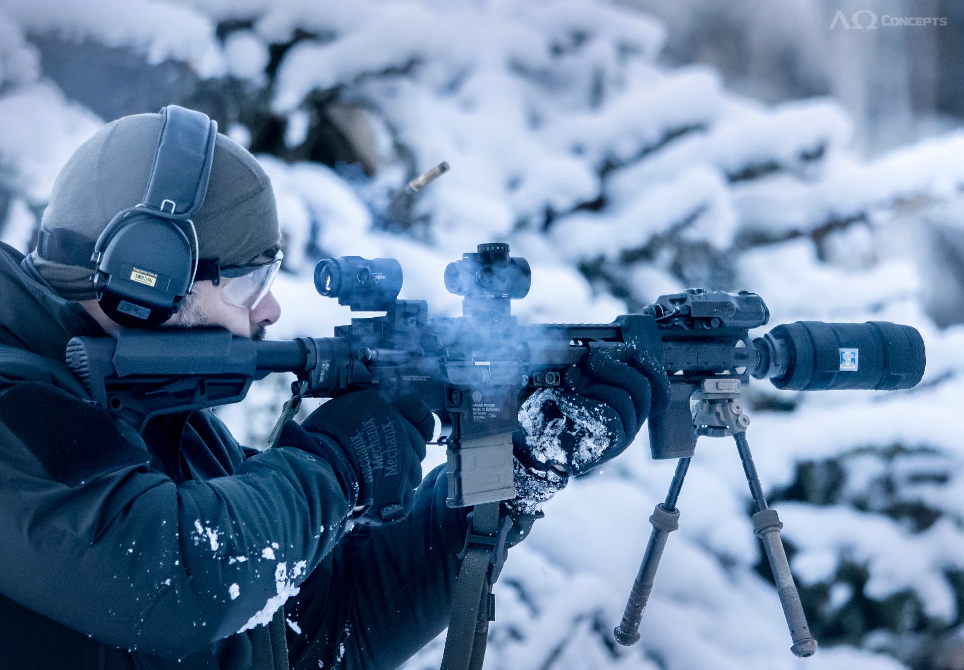 Rifle with suppressor cover fired on a bipod in the snow